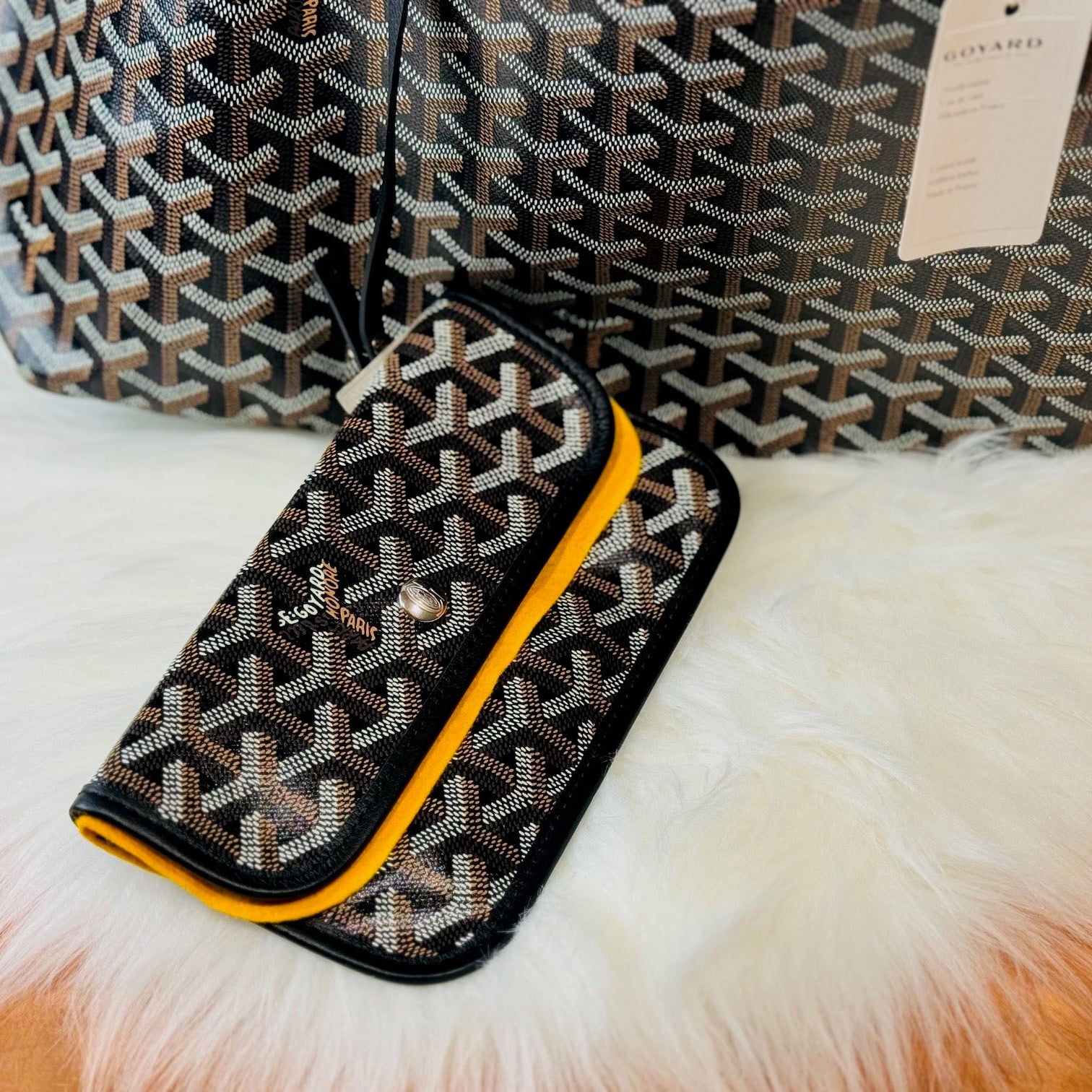 Patterned handbag with yellow accent on a fur surface