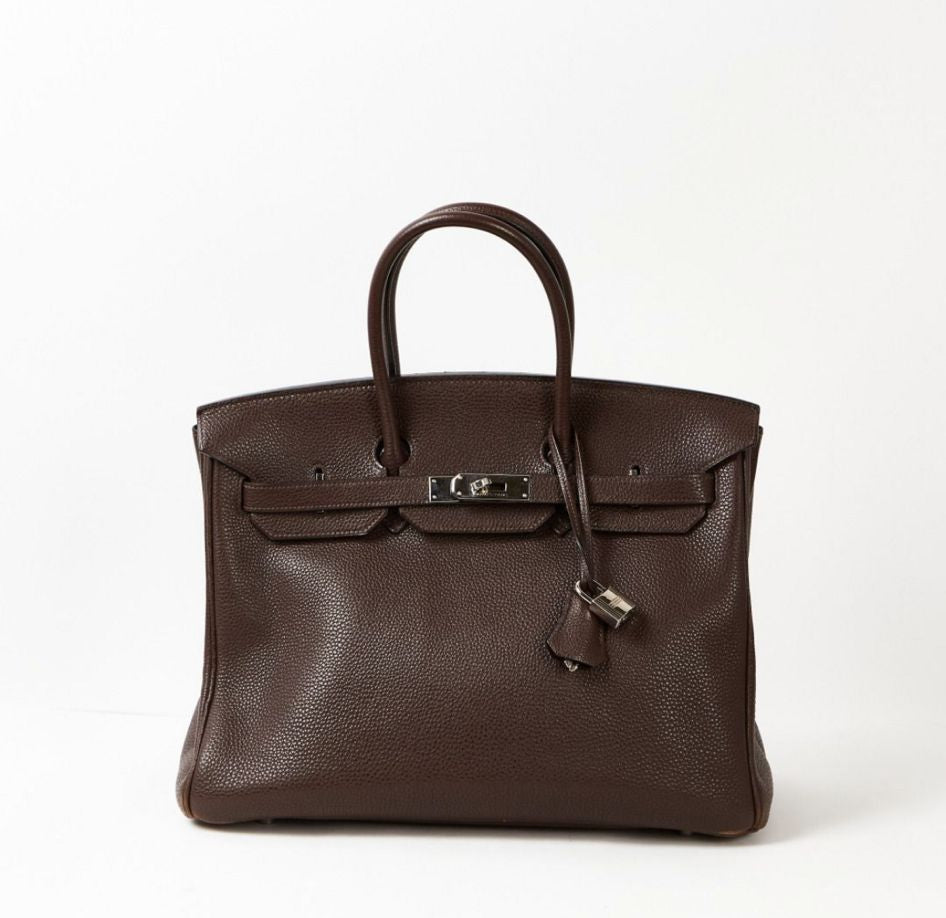 Brown leather handbag on a white background