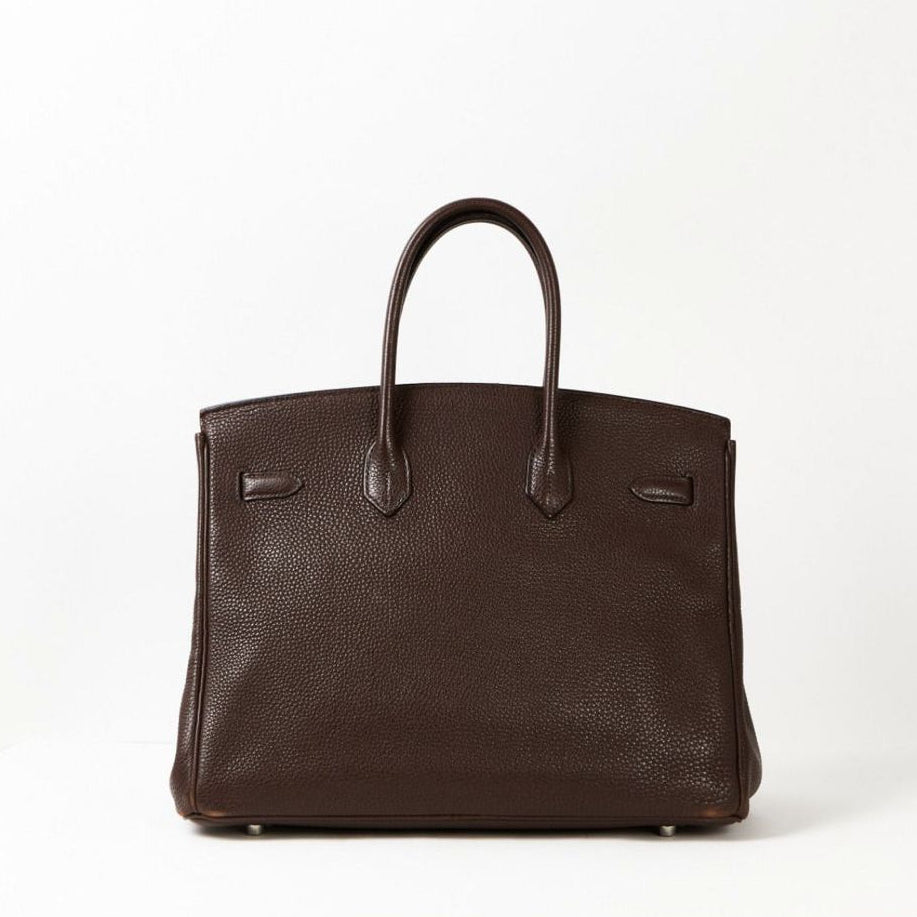 Brown leather handbag on a white background