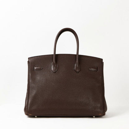 Brown leather handbag on a white background